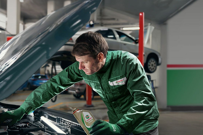 A photograph of a Castrol Service technician in action