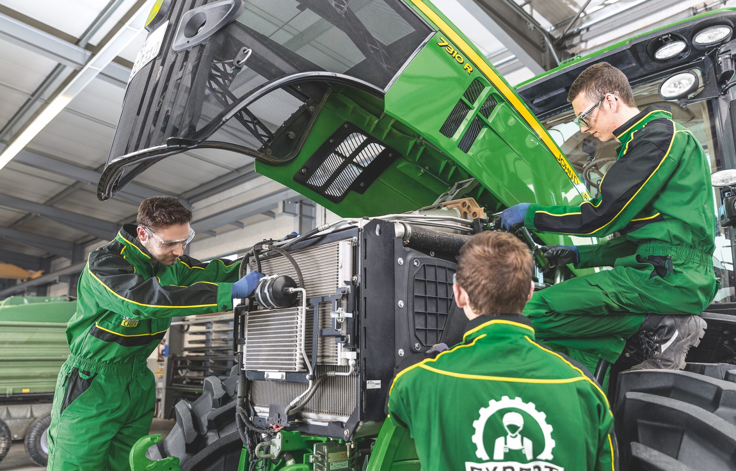 John Deere apprentices working on a John Deere Ag Tractor